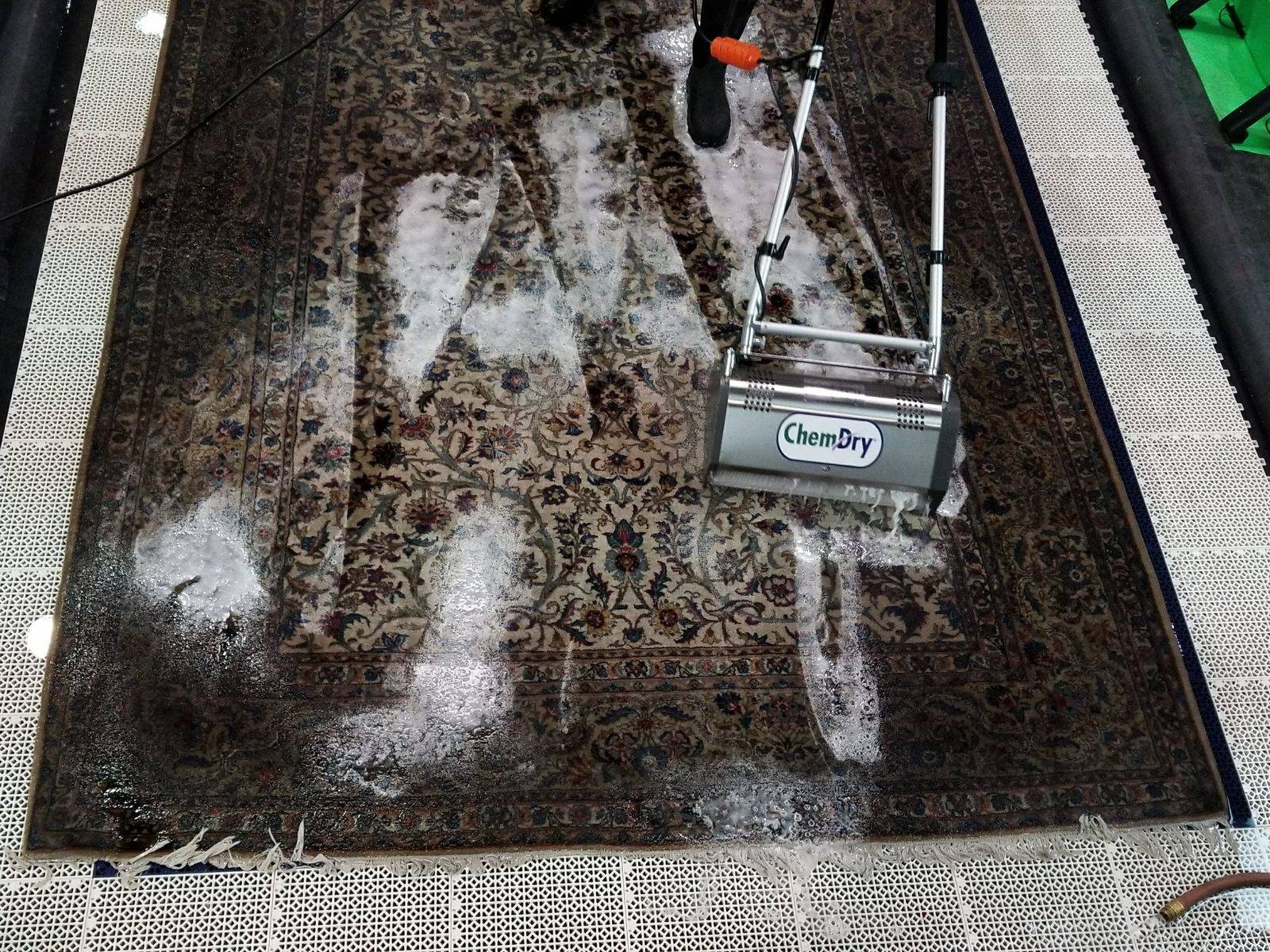 Oriental rug being washed in a rug cleaning pit